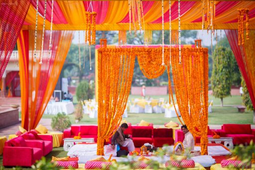 traditional mandal design decorated with Marigold Flowers and with Pink & Orange Layered drapes