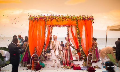 Orange beach wedding mandap decorated with Roses & Ferns