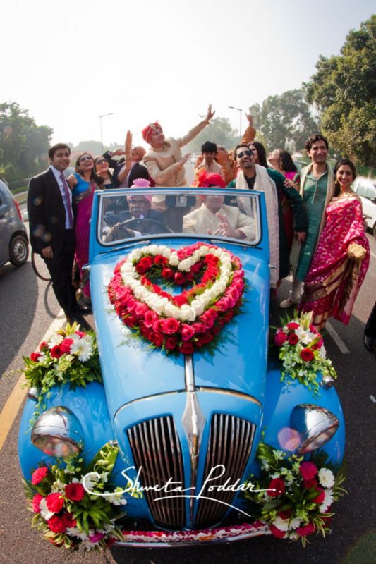 Groom entry in decorated vintage car at his wedding