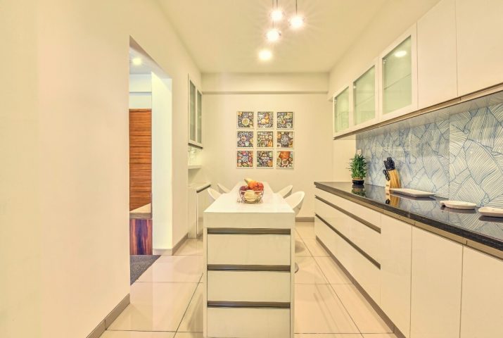 White kitchen with island and blue backsplash