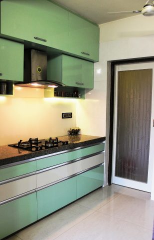 Green modular kitchen with horizontal cabinets and granite countertop