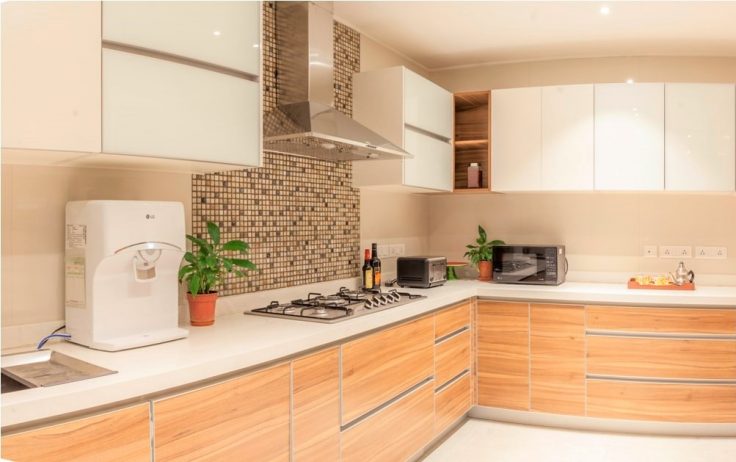 White and brown themed L-shaped kitchen